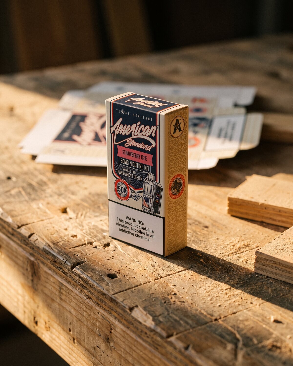 FIG.03 — the first die-cut carton blank, scored and half-folded on the bench